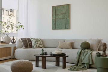 Elegant sofa space with green accents and soft textures, creating a warm, tranquil environment.