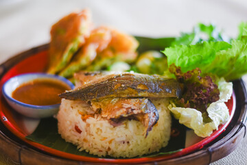 Shrimp paste sauce with crispy fried fish and sweet pork in a plate
