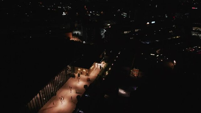 Palas development lit rooftop at night, urban Romania