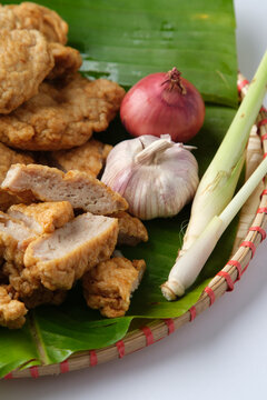 Deep fried Cha Lua slices served on a banana leaf in a woven basket.