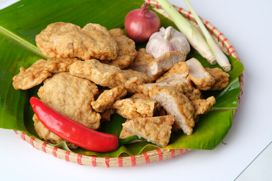Deep fried Cha Lua slices served on a banana leaf in a woven basket.