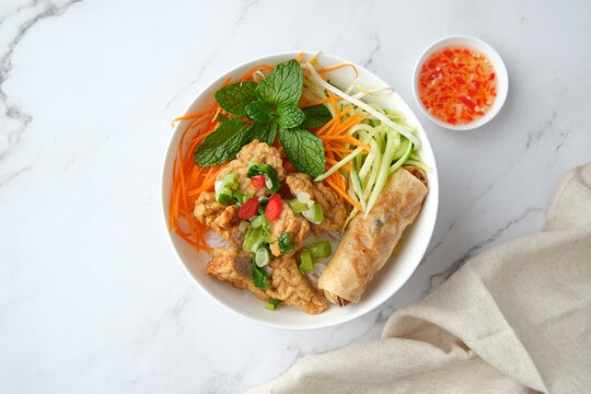 Bun Cha Gio bowl topped with fried spring roll and Cha Lua.