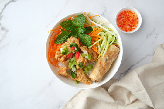 Bun Cha Gio bowl topped with fried spring roll and Cha Lua.