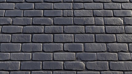 Obraz premium A tight shot of a gray brick wall, composed of compact blocks, devoid of mortar joints