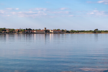 Obraz premium Scenic view of picturesque coastal town Dajla seen from shoreline of Karigador, Istria peninsula, Croatia, EU. Village is nestled along the waterfront of Adriatic Mediterranean sea. Summer vacation