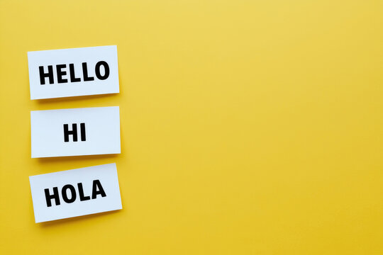 "World hello day". Stickers with text "Hi", "Hola", "Hello" on yellow background. November 21. AI generated