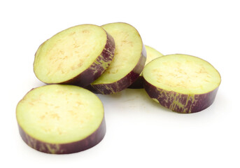 Aubergine, Solanum melongena, egg plant, single ripe fruit and halved fruit next to it - stock photo
