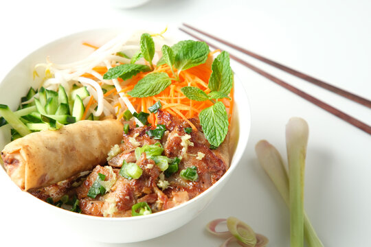 Bun Cha Gio bowl with meat slices topped with fried spring roll.