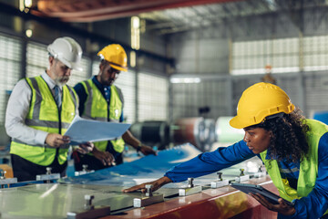 Foreman or worker work at factory site check up machine or products in site.