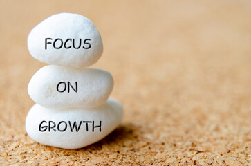 Focus on Growth text engraved on white stones. Strength and focus concept
