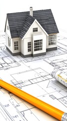 Architectural blueprints with a model house and construction tools on a design table for modern home planning