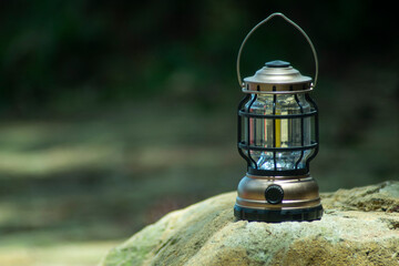 rechargeable lantern led light on rock  © rangga