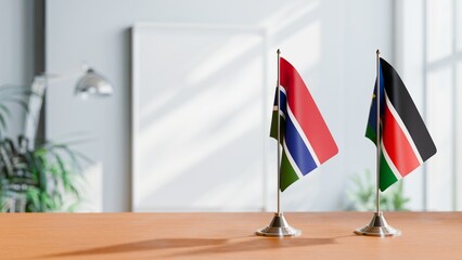 FLAGS OF GAMBIA AND SOUTH SUDAN ON TABLE
