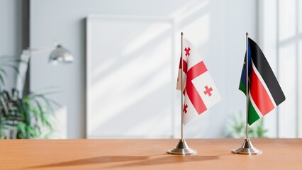FLAGS OF GEORGIA AND SOUTH SUDAN ON TABLE