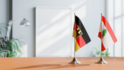 FLAGS OF GERMANY AND LEBANON ON TABLE