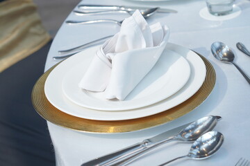 table setting with cutlery, plates, spoon and folk