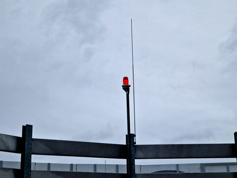 lightning conductors and red parking lights need to be installed on the roofs of tall buildings and industrial halls due to collisions with airplanes and helicopters in fog and at night. near airport