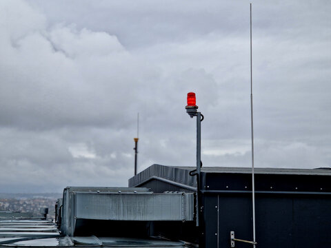 lightning conductors and red parking lights need to be installed on the roofs of tall buildings and industrial halls due to collisions with airplanes and helicopters in fog and at night. near airport