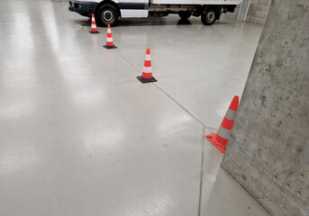 newly painted garage floor with gray latex paint. the surface is glossy and easy to maintain and wash. resistant to oil and chemicals. it looks wet and shines