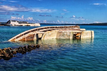 Obraz premium Old damaged and rusty shipwreck on the seafront with blurry sky background.
