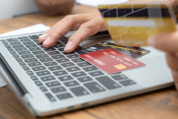 Fototapeta premium Man using credit card and laptop for online shopping