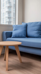Modern blue sofa and wooden coffee table in a contemporary apartment setting near a window