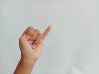 Asian kid's hand do Pinky promise symbol or pinkie swear hands gesture on white background, with copy space