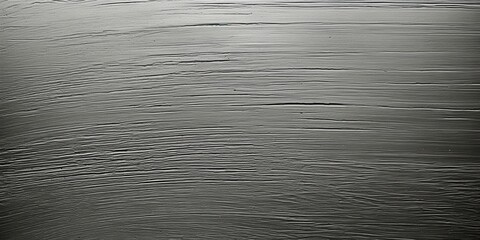 A smooth and textured surface with a pattern of horizontal lines, creating an abstract design with a subtle sheen and an interesting tactile quality.