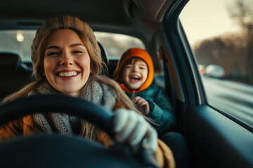 Young happy mother with driving a car with her laughing son