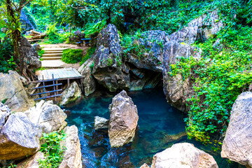 Tham Chang cave with water source river in Vang Vieng Laos.