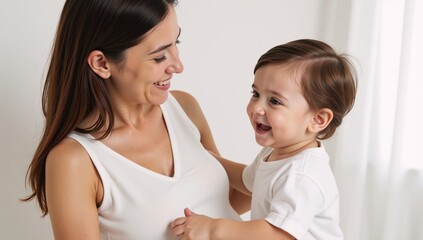Smiling mother-child duo on a white backdrop capturing their heartwarming bond