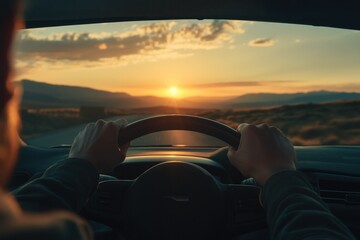 Scenic Drive at Sunset with Hands on Steering Wheel