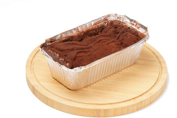 Belgian chocolate milk bun on a wooden plate with a white background. Soft bun filled with creamy Belgian chocolate and dusted with chocolate powder. Sweet, melt-in-mouth, best chilled.