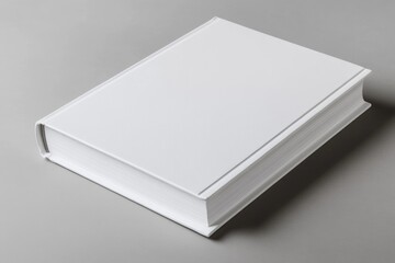 Fototapeta premium White book with a leather cover sits on a grey surface. The book is empty and has no writing on it. Concept of emptiness and simplicity, as the book is devoid of any content