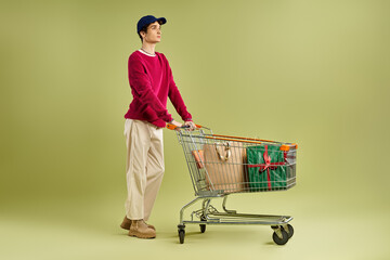 A fashionable young man with curly hair revels in the excitement of Black Friday, holding shopping...