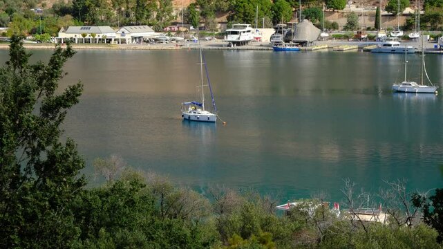 Yachts and boats moored in the harbor of Kas, Turkey. The sun is shining, and water is calm. Sailing paradise , Yachts and boats gracefully navigate azure waters against of this coastal