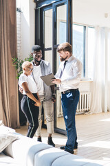Formal salesman and black owners discussing new home deal