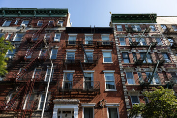 Row of Beautiful Old Brick Apartment Buildings with fire escapes in Greenwich Village of New York City