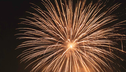 Closeup of Golden Fireworks Display Illuminating the Night Sky in Celebration, with Burst of Bright Lights and Sparkling Trails against Dark Backdrop - Bonfire night, new Year Celebrations