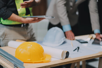 Team Engineers with draft plan of building on constructing site. Engineer work on site. engineer visit and inspection site engineer. Inspector engineer check and working on site.