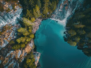 Obraz premium Beautiful blue lake surrounded by trees. The water is calm and clear, and the trees are lush and green. The scene is peaceful and serene, and it evokes a sense of calm and relaxation