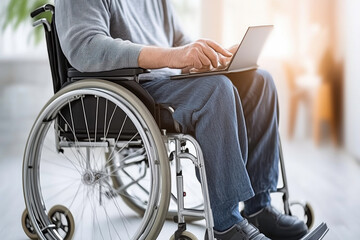 Obraz premium Professional using laptop while seated in wheelchair