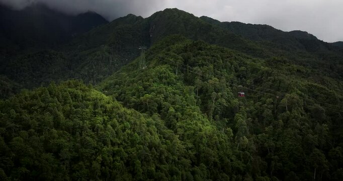Aerial view of Sun World cable car moving up to summit of lush Fansipan, Vietnam