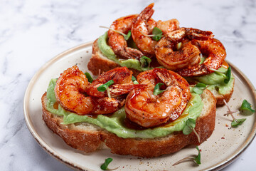 sandwiches with avocado and caramelized shrimp, micro-greens, breakfast, on a plate, top view, homemade, no people,