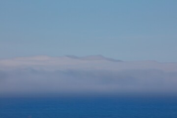 Obraz premium Varanger peninsula covered in sea mist in summer, Norway.