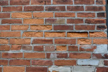 old weathered brown orange tan neutral brick tile building facade spalled background