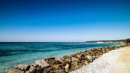 Breakwater on beach in Vada, Italy.