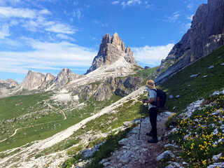 Fototapeta premium Ragazzo escursionista in montagna, trekking in the mountains, Dolomiti, Alpi