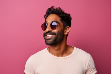 Obraz premium Portrait of a satisfied indian man in his 30s donning a trendy cropped top isolated in solid color backdrop