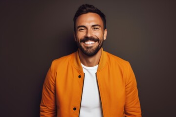 Obraz premium Portrait of a cheerful man in his 30s wearing a trendy bomber jacket isolated on solid color backdrop
